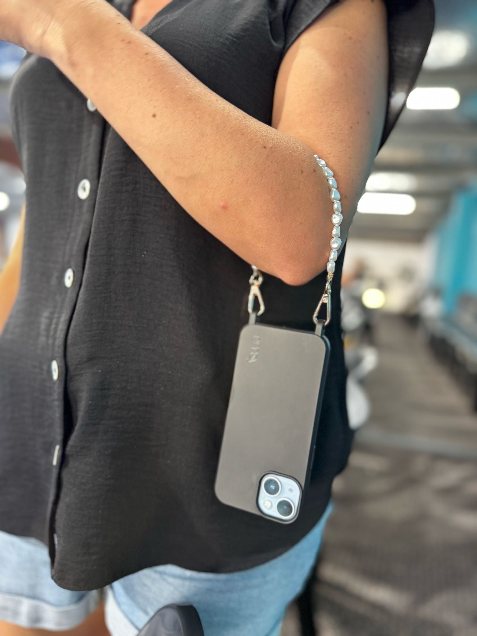 Close-up of a chic pearl phone wristlet, as seen on Netflix's Emily in Paris. This elegant accessory combines timeless style with modern functionality, perfect for adding a touch of Parisian flair to any outfit. Phone Accessory for any girl and any phone.