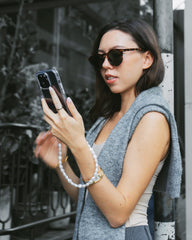 Netflix Emily in Paris Pearl Phone Case Emsy Australia crossbody phone cases are compatible with iPhone, Samsung models. The cases offer protection with durable cords, keeping phones secure with fashionable coloured ropes to elevate your style.