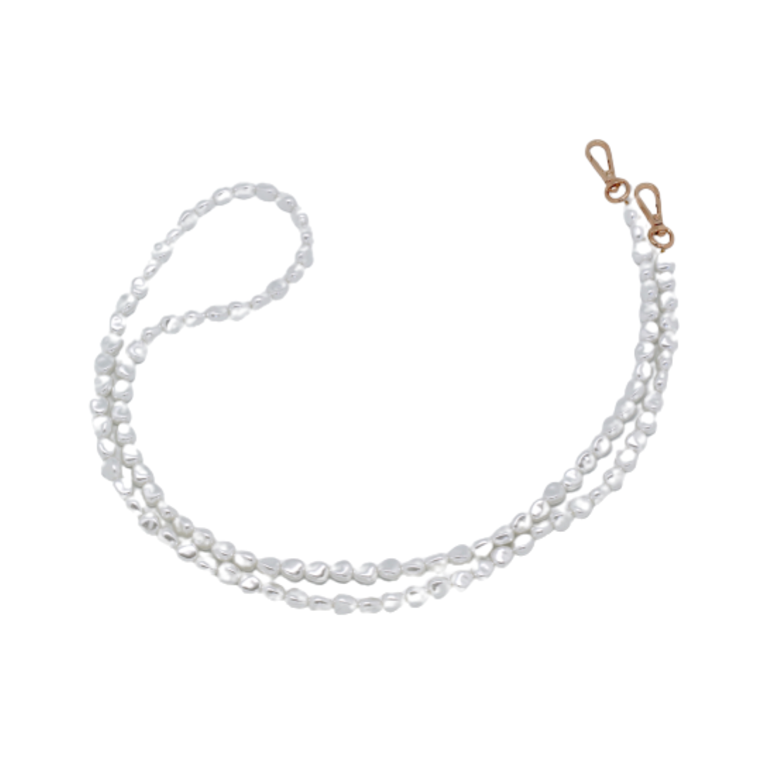 Close-up of a chic pearl phone wristlet, as seen on Netflix's Emily in Paris. This elegant accessory combines timeless style with modern functionality, perfect for adding a touch of Parisian flair to any outfit. Phone Accessory for any girl and any phone.