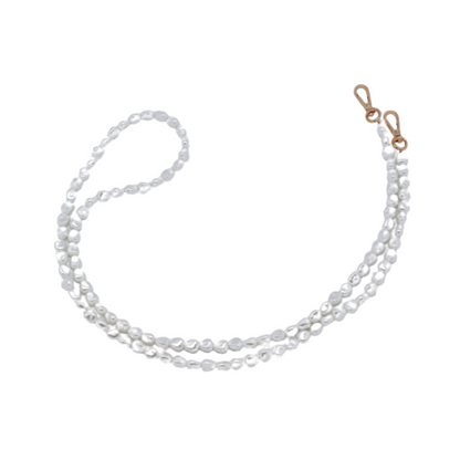 Close-up of a chic pearl phone wristlet, as seen on Netflix's Emily in Paris. This elegant accessory combines timeless style with modern functionality, perfect for adding a touch of Parisian flair to any outfit. Phone Accessory for any girl and any phone.