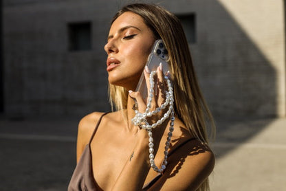Netflix Emily in Paris Pearl Phone Case Emsy Australia crossbody phone cases are compatible with iPhone, Samsung models. The cases offer protection with durable cords, keeping phones secure with fashionable coloured ropes to elevate your style.